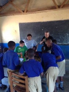 Judith, Timmy and Dave watch on as the students of St. Joseph's Primary School play their first few games of Chesss - Nabbingo, Uganda