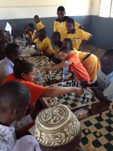 Timmy & Judy play Chess against the Teachers as the Learners from St. Lawrence Primary School look on - Migyera, Uganda