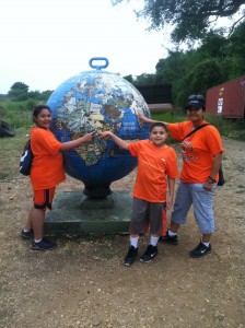 Ev & the kids pointing to Uganda on the Globe at Murchison Falls, Uganda