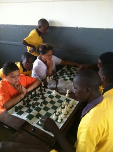 Timmy is playing Kizuto while Judith plays another St. Lawrence Student while a few learners look on.